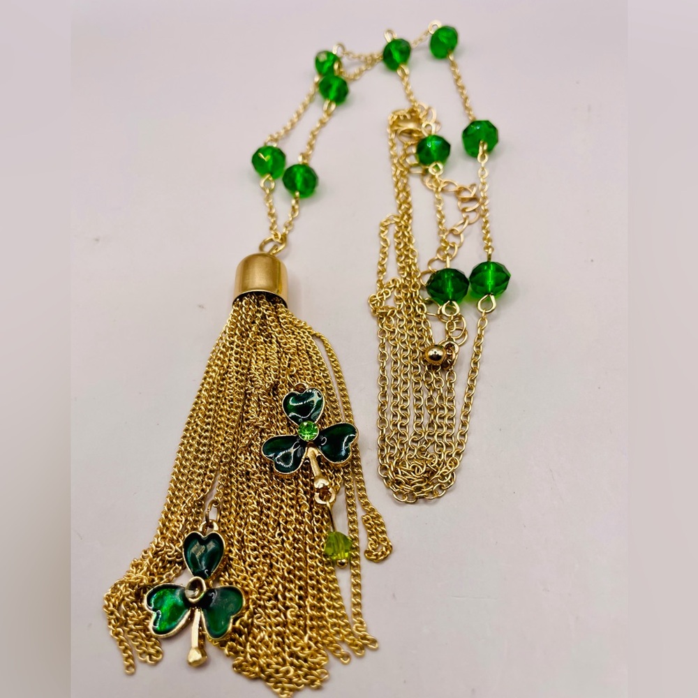Green bead station necklace with green clover chain tassel. Gold tone. 34 inch
